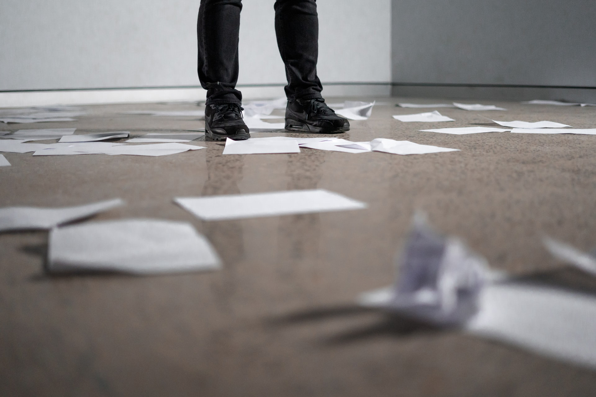 Feet on floor with papers