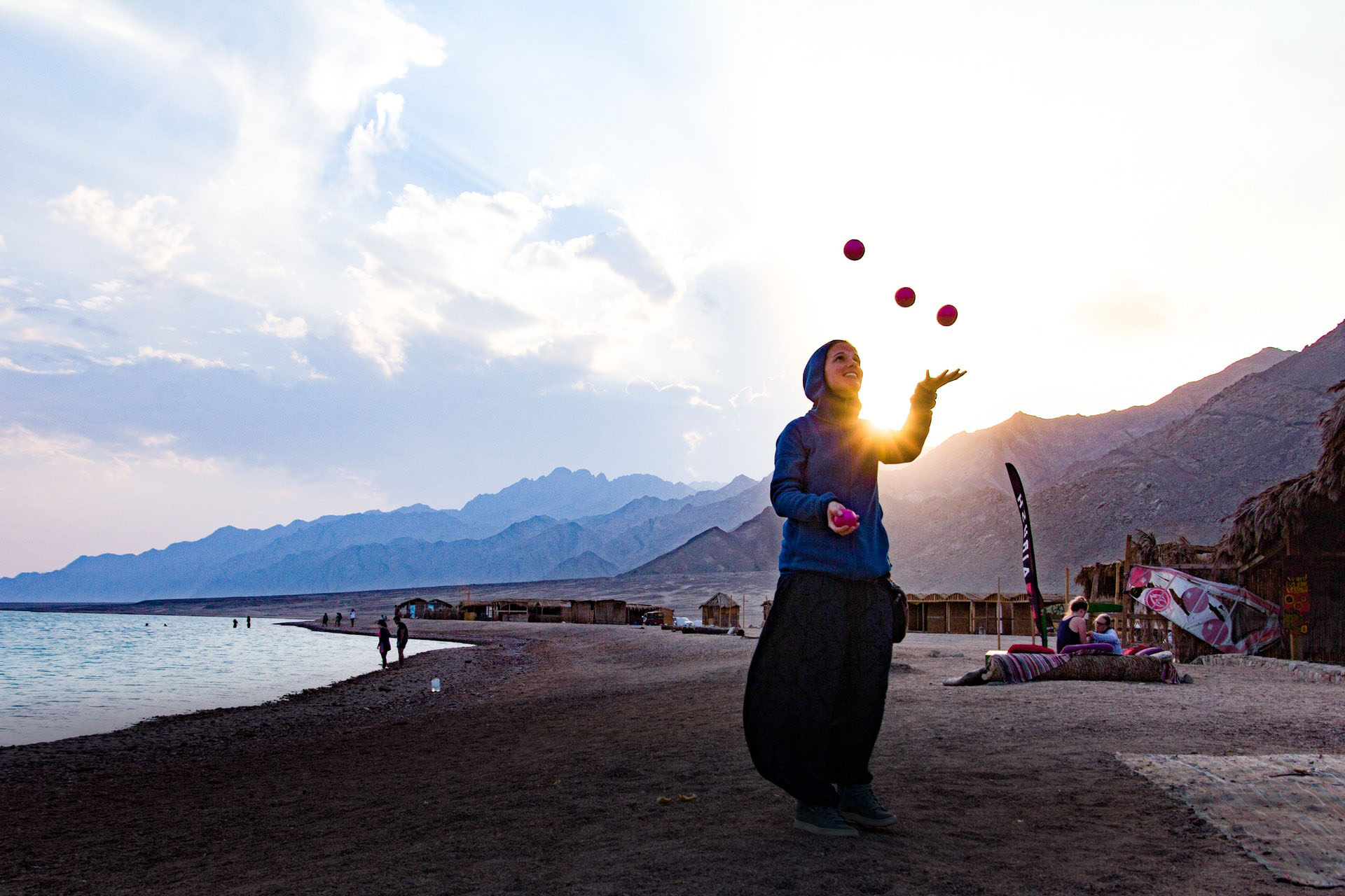 Woman juggling on beach