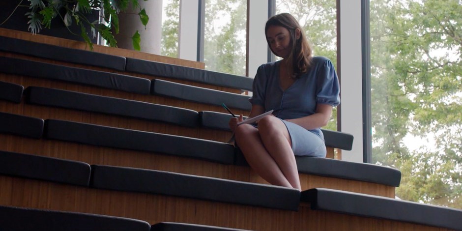 women sitting on stairs reading
